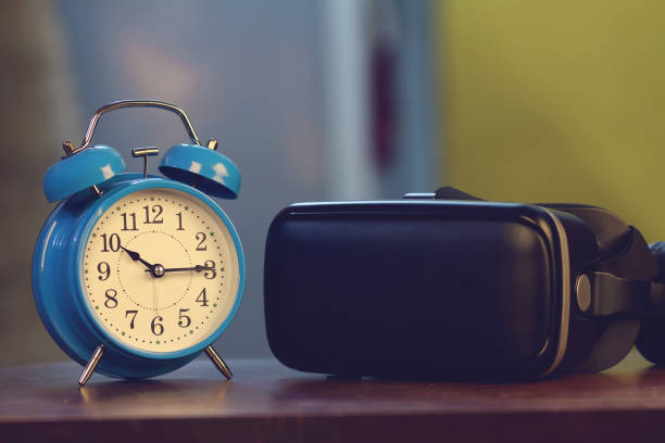istock Retro alarm clock and new technology VR glasses 1249497864