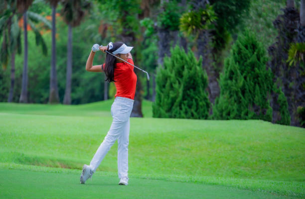 istock Woman golfer playing golf on the field 1249500514