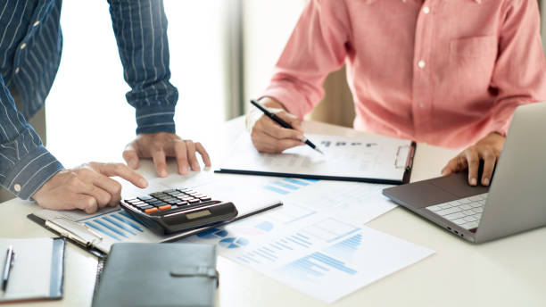 istock Business team working with plan on office desk with new startup project analyzing financial document data charts and graphs in Meeting and successful teamwork Concept 1249500541