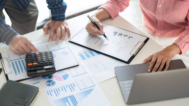 istock Business team working with plan on office desk with new startup project analyzing financial document data charts and graphs in Meeting and successful teamwork Concept 1249501707