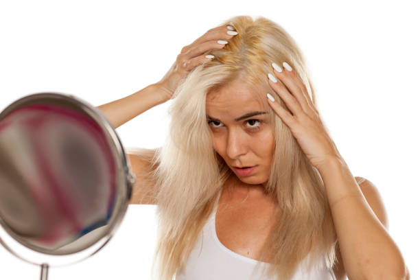 istock blonde woman looking her scalp 1249506406