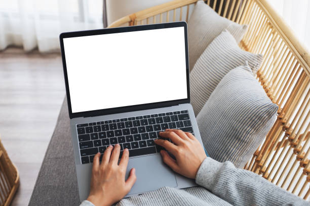 istock a woman working and typing on laptop computer with blank screen while sitting on a sofa at home 1249507569