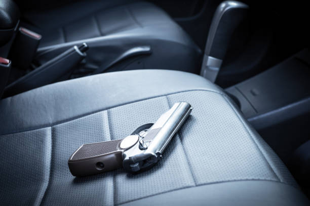 the gun is on the car seat. criminal district of the city illegal possession of weapons gun stock pictures, royalty-free photos & images