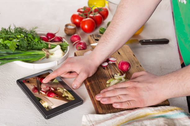 istock Man preparing vegetable salad at home in the kitchen, close up 1249507822
