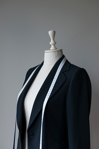 Close-up of female tailor's mannequin with measuring tape.