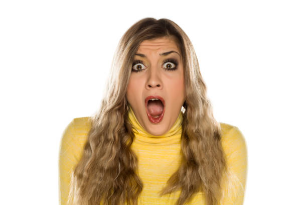 istock Pretty blonde with makeup, and long wavy hair making silent gesture 1249510360