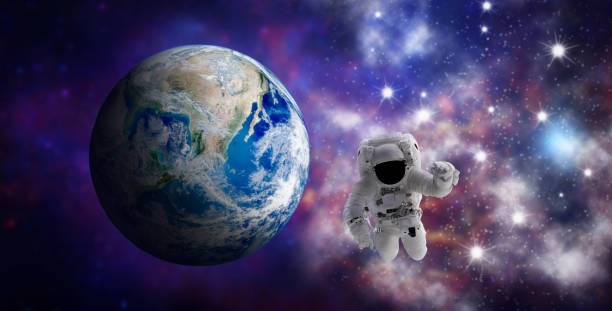 istock Astronaut floating in space with blurry image of blue planet earth in background. 1249510921