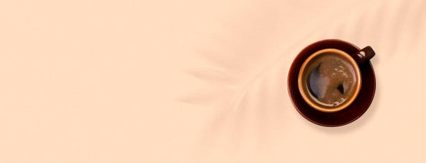 istock Cup of coffee on a light background. Banner. Top view.  Coffee background with space for text 1249511982