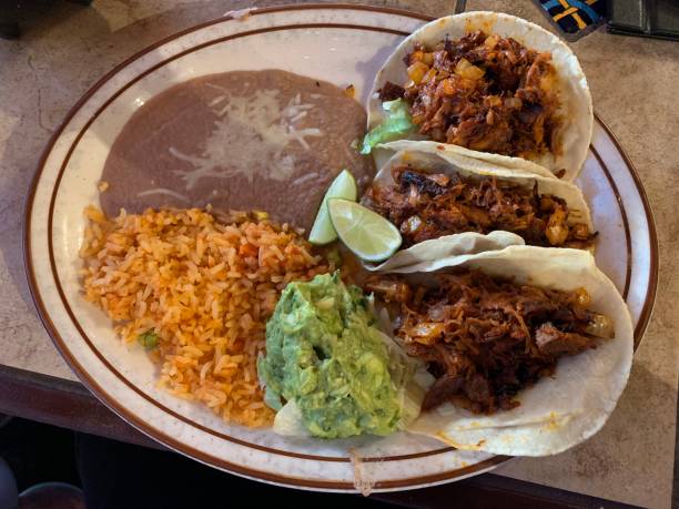 istock Three fresh Al Pastor tacos on a plate 1249513721