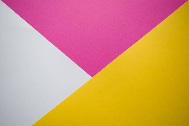 istock White, pink and yellow background divided diagonally 1249515330