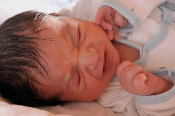 istock Newborn baby crying because of colic 1249519310