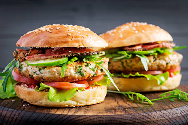 Big sandwich - hamburger burger with turkey meat, tomato, bacon and lettuce. Big sandwich - hamburger burger with turkey meat, tomato, bacon and lettuce. TURKEY BURGER stock pictures, royalty-free photos & images