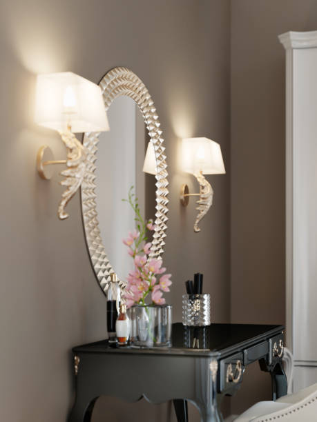 istock A round mirror with a golden rim on the wall, two sconces on each side, above the dressing table. 1249524572