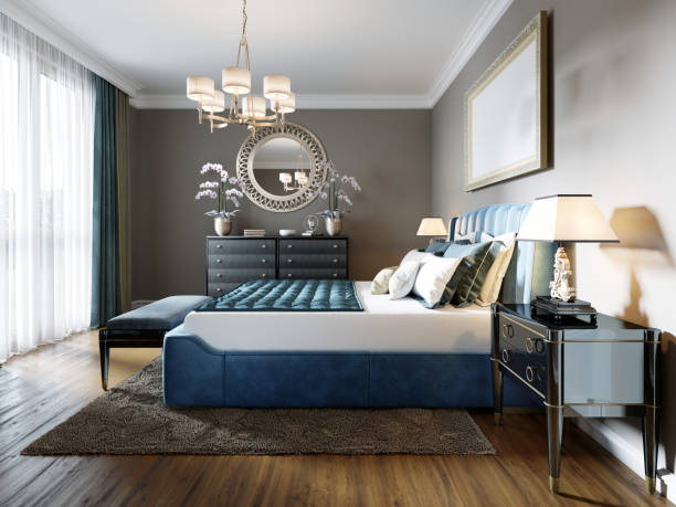istock A modern bedroom in an eclectic style. With a double blue bed, black dressing table and chest of drawers with decor. beige walls and white wardrobe. 1249525411