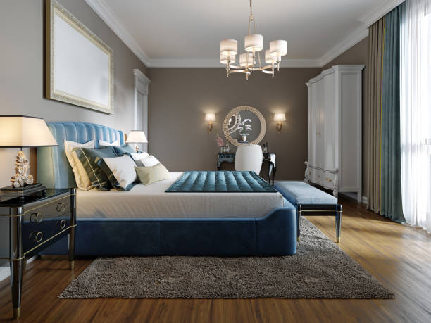istock A modern bedroom in an eclectic style. With a double blue bed, black dressing table and chest of drawers with decor. beige walls and white wardrobe. 1249525470