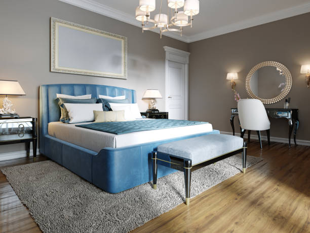 istock A modern bedroom in an eclectic style. With a double blue bed, black dressing table and chest of drawers with decor. beige walls and white wardrobe. 1249525608
