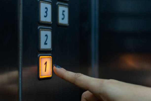 istock finger presses the elevator button. hand reaches for the button of the elevator 1249528222