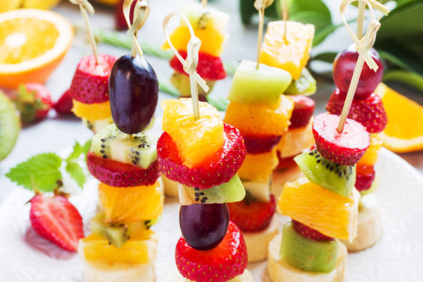istock Fresh fruit on skewers. Concept buffet for a summer party. 1249531812