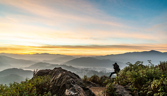 A Photographer in action during sunrise in the mountains in Uttarakhand India