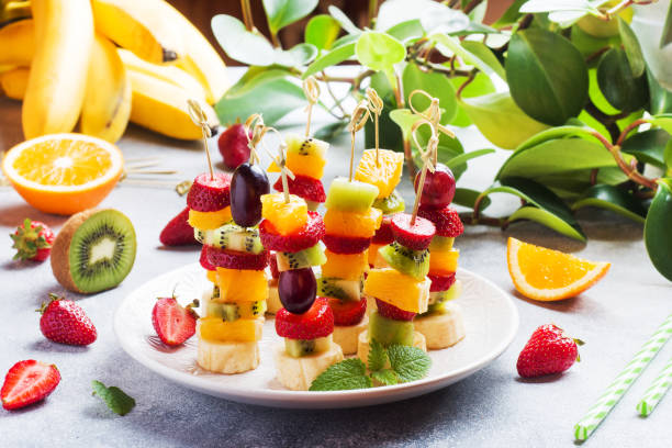 istock Fresh fruit on skewers. Concept buffet for a summer party. 1249532022