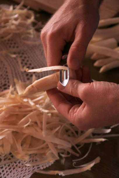 istock Peeling and cutting white asparagus 1249533116