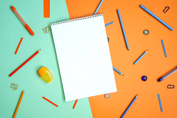 istock Stationery on turquoise and orange. Flat lay. 1249534104