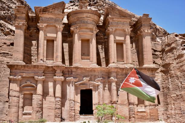 istock Petra Monastery with Jordanian Flag 1249535866