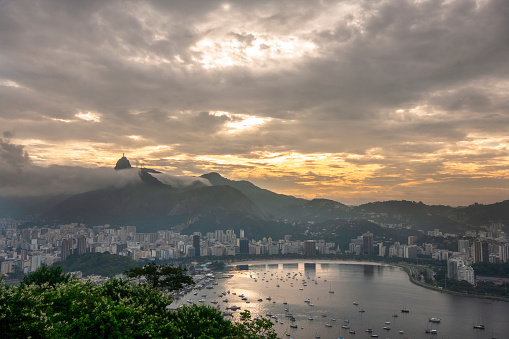 a rio de janerio scape christ redeemer is top of the city cloudy sunset