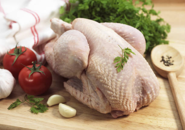istock CHICKEN READY TO COOK WITH TOMATO, GARLIC AND PARSLEY 1249541459