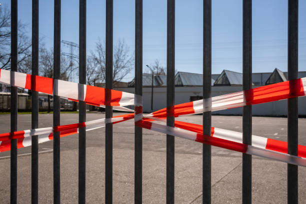 Barrier at factory gate with Weis Red barrier tape stock photo