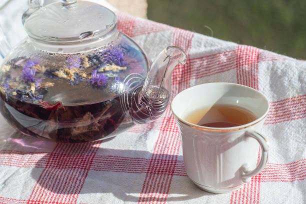 istock Kettle and cup with brewed fruit tea on the windowsill 1249548931