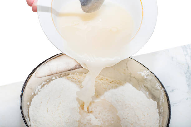 istock Close-up of a liquid base for dough that is poured into flour 1249548987