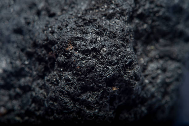 istock Blurred black background in soft focus with hard coal at high magnification 1249549024