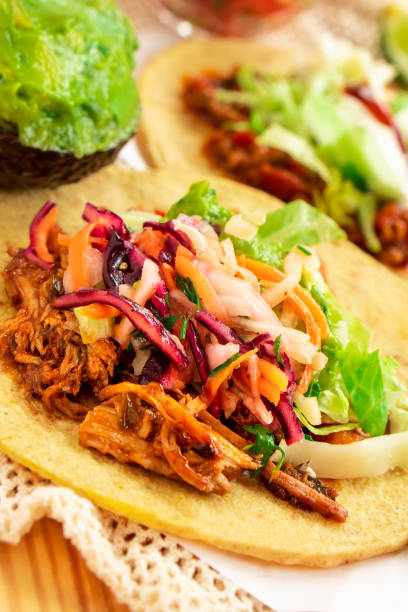 istock Mexican traditional authentic homemade tacos with pulled pork beef chili con carne serve with tomato salad and avocado guacamole and dip sauce 1249551478