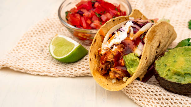 istock Mexican traditional authentic homemade tacos with pulled pork beef chili con carne serve with tomato salad and avocado guacamole and dip sauce 1249552370
