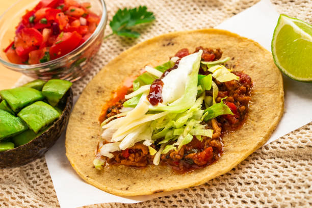 istock Mexican traditional authentic homemade tacos with pulled pork beef chili con carne serve with tomato salad and avocado guacamole and dip sauce 1249552396