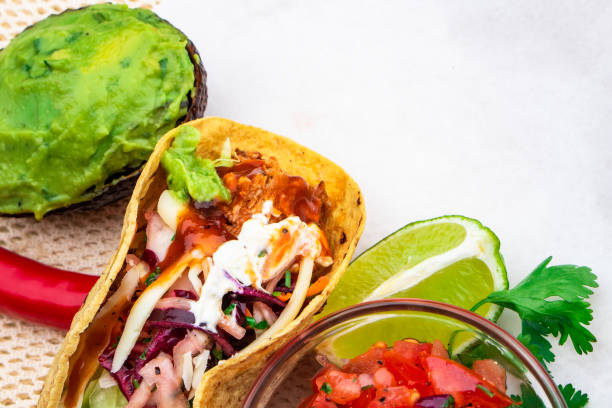 istock Mexican traditional authentic homemade tacos with pulled pork beef chili con carne serve with tomato salad and avocado guacamole and dip sauce 1249552423