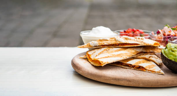 istock Mexican traditional authentic homemade quesadilla with pulled pork beef chili con carne serve with tomato salad and avocado guacamole and dip sauce 1249552438