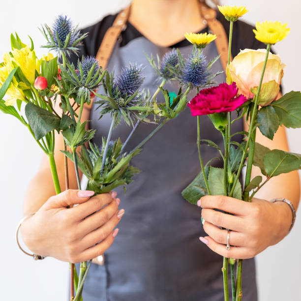 istock Florist woman holding different flowers 1249552504