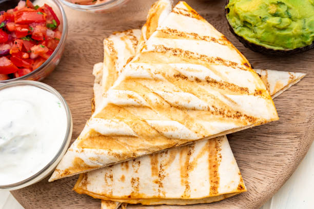 istock Mexican traditional authentic homemade quesadilla with pulled pork beef chili con carne serve with tomato salad and avocado guacamole and dip sauce 1249552592