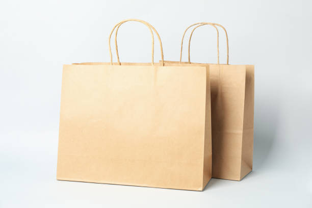 istock Empty paper bags on white background, space for text 1249553332
