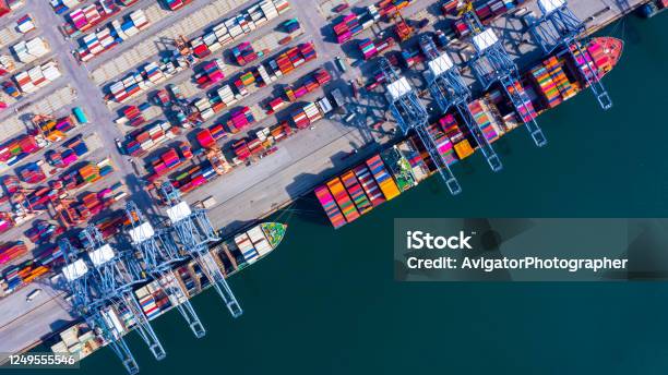 Container Ship At Industrial Port In Import Export Global Business Worldwide Logistic And Transportation Container Ship Unloading Freight Shipment Aerial View Container Cargo Vessel Boat Freight Ship Stock Photo - Download Image Now