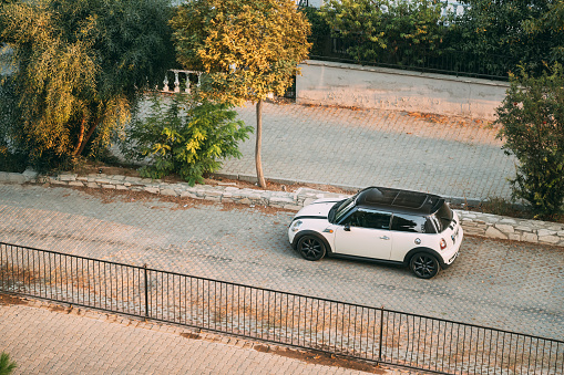 Kusadası, Turkey - September 12, 2019: Top View Of White Color 2004 Mini One Hatch Mini Cooper Car Parking On Street