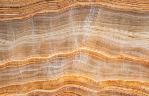 Close- up texture of yellow parallel layered marble onyx