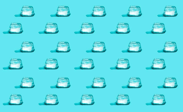 istock Abstract seamless pattern made of melting ice cubes on a light-blue background. 1249560655