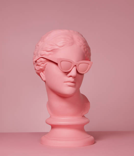 Pink colored modern Greek Goddess with sunglasses Pink toned plaster head model (mass produced replica of Head of Aphrodite of Knidos) with sunglasses Sculpture stock pictures, royalty-free photos & images