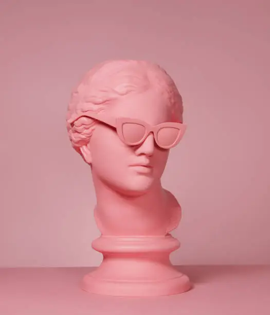 Pink toned plaster head model (mass produced replica of Head of Aphrodite of Knidos) with sunglasses