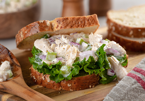 Closeup of chicken salad sandwich with lettuce on whole grain bread