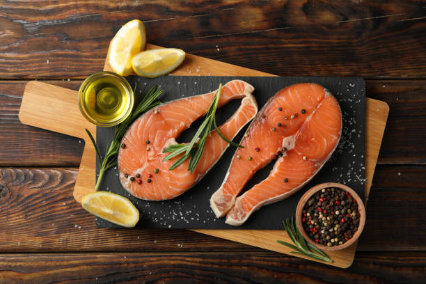 istock Composition with salmon meat and spices on wooden background, top view 1249565373