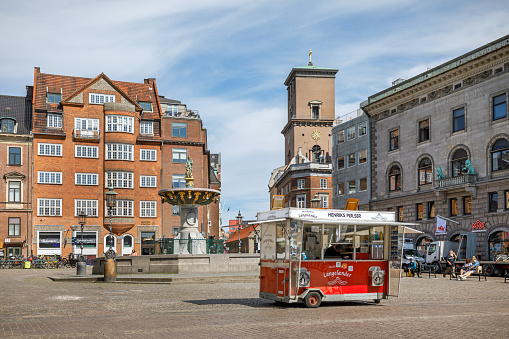 Vor Frue Kirke, Our Lady Church, Copenhagen, Denmark, June 10, 2020: Church tower with a traditional fast food stall in the front, the church is the cathedral of Copenhagen